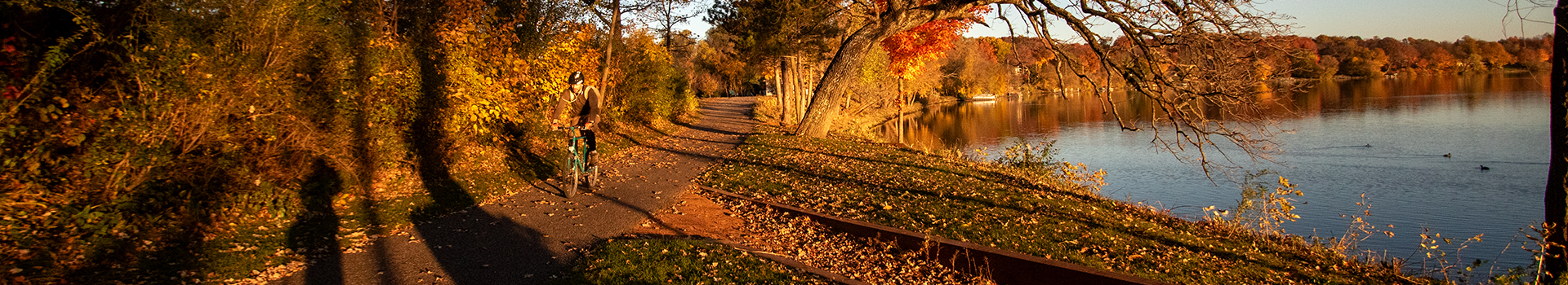Photo of a person biking near a lake in Plymouth