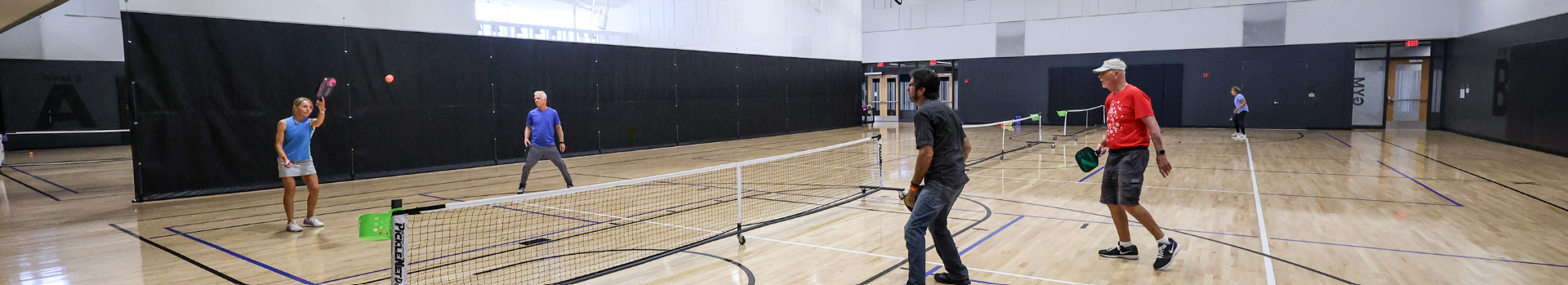 Image of people playing pickleball on a gymnasium